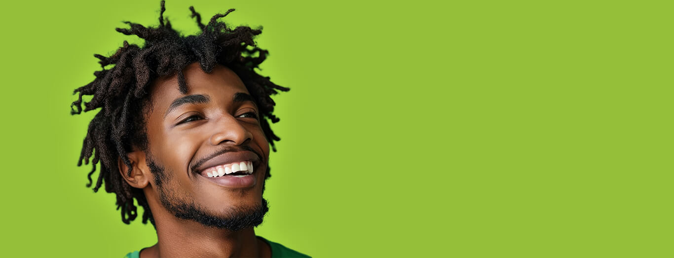 Photo of an African American man with locs smiling