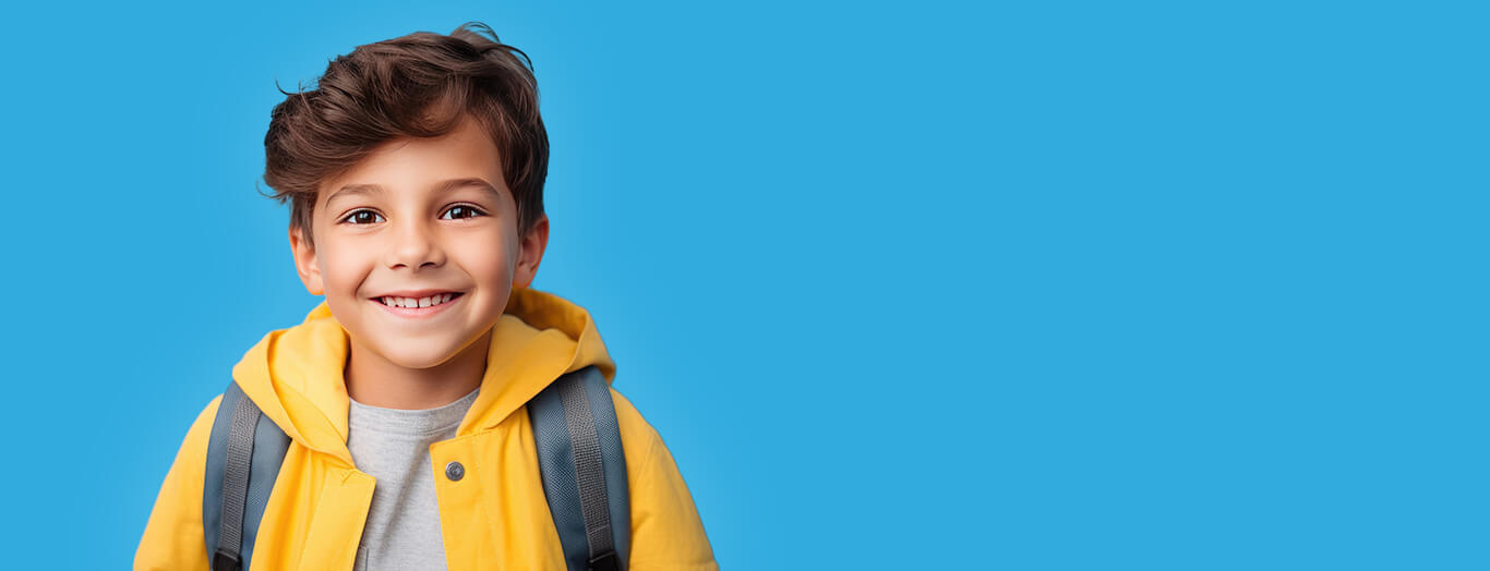 Photo of a smiling young boy wearing a backpack